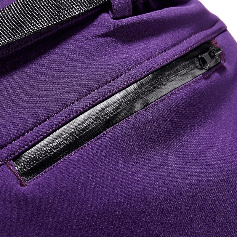 Close-up of purple windproof waterproof fleece women's hiking pants with a zippered pocket, SF0223, showing fabric texture and design.